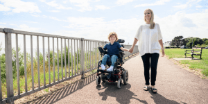 Mother and wheelchaired son outside