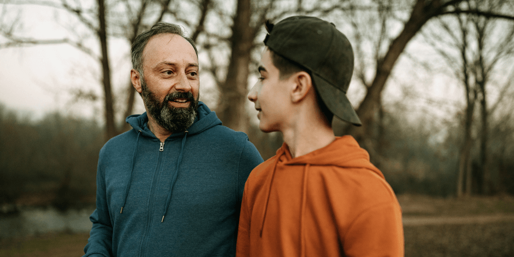 Teenage son and father walking dad