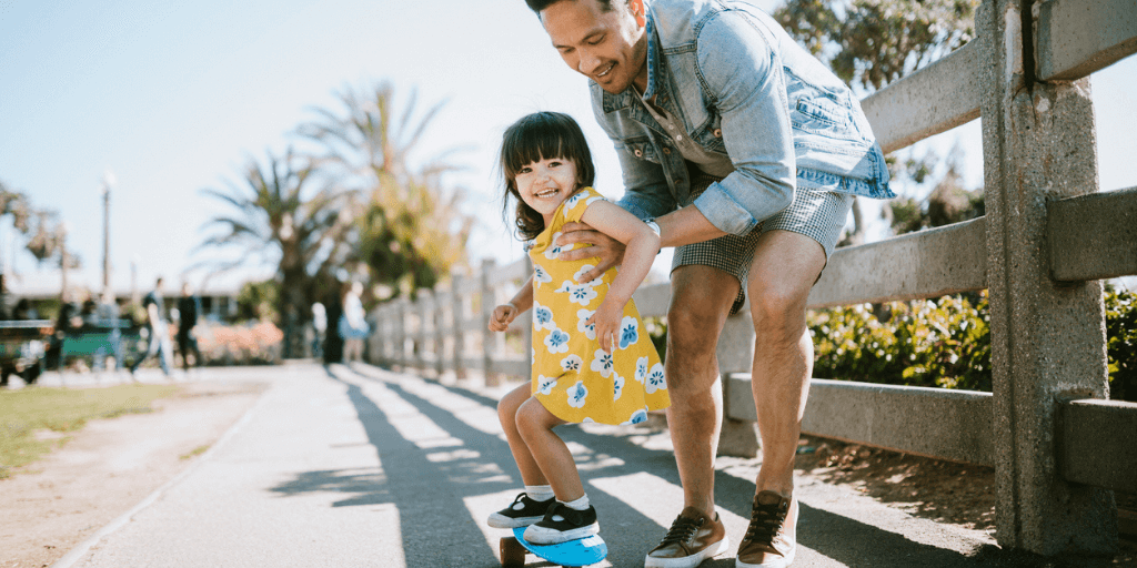 Father skateboarding with daughter