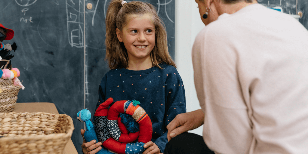 child playing with Big Tree Doll Molly and therapist 1