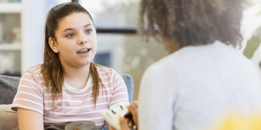 teenage girl talking to counsellor