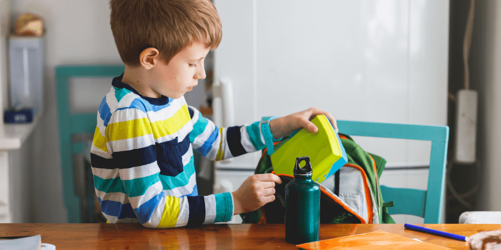 child packing his bag for school transition