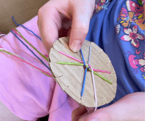 Sophie* weaving with colourful threads. 